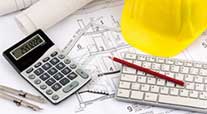 Image of calculator, computer keyboard, building plans and yellow site helmet 